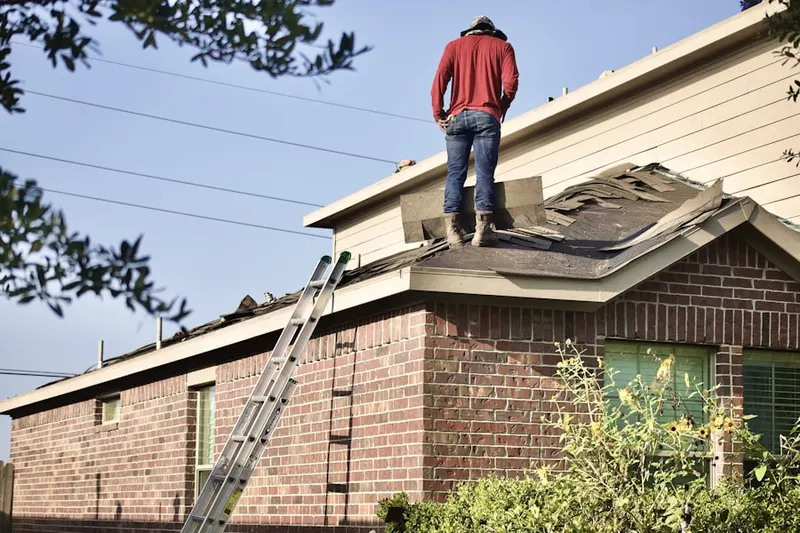 Professional roofer working on a residential roof in New Hope Park Place